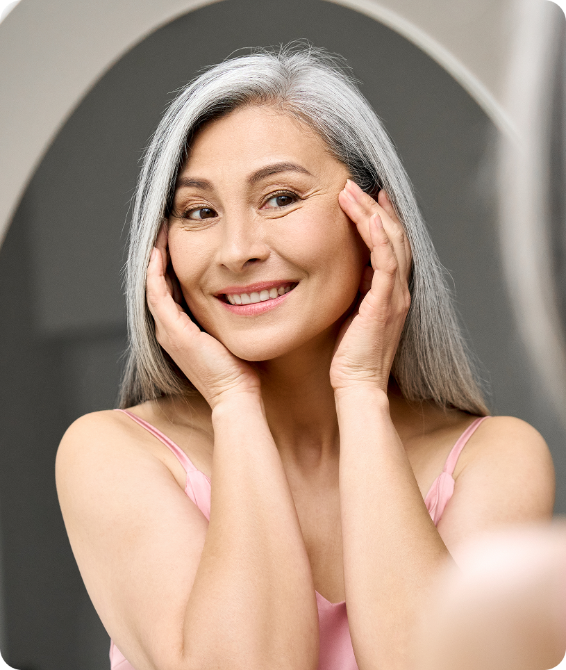 Woman with hair in front of a mirror, likely in a beauty salon